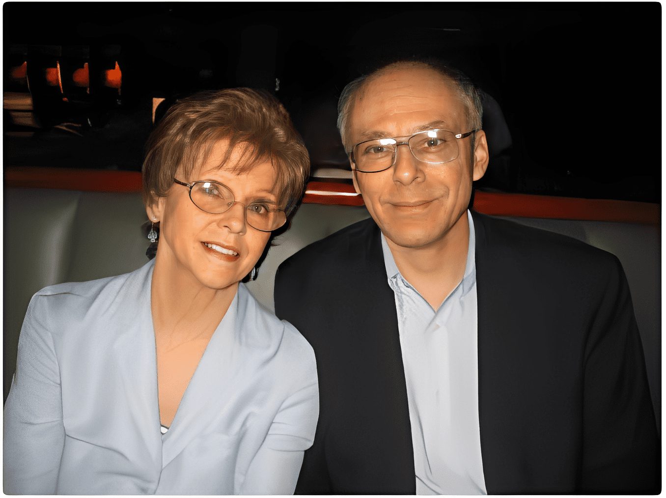 Couple posing in a dimly lit room