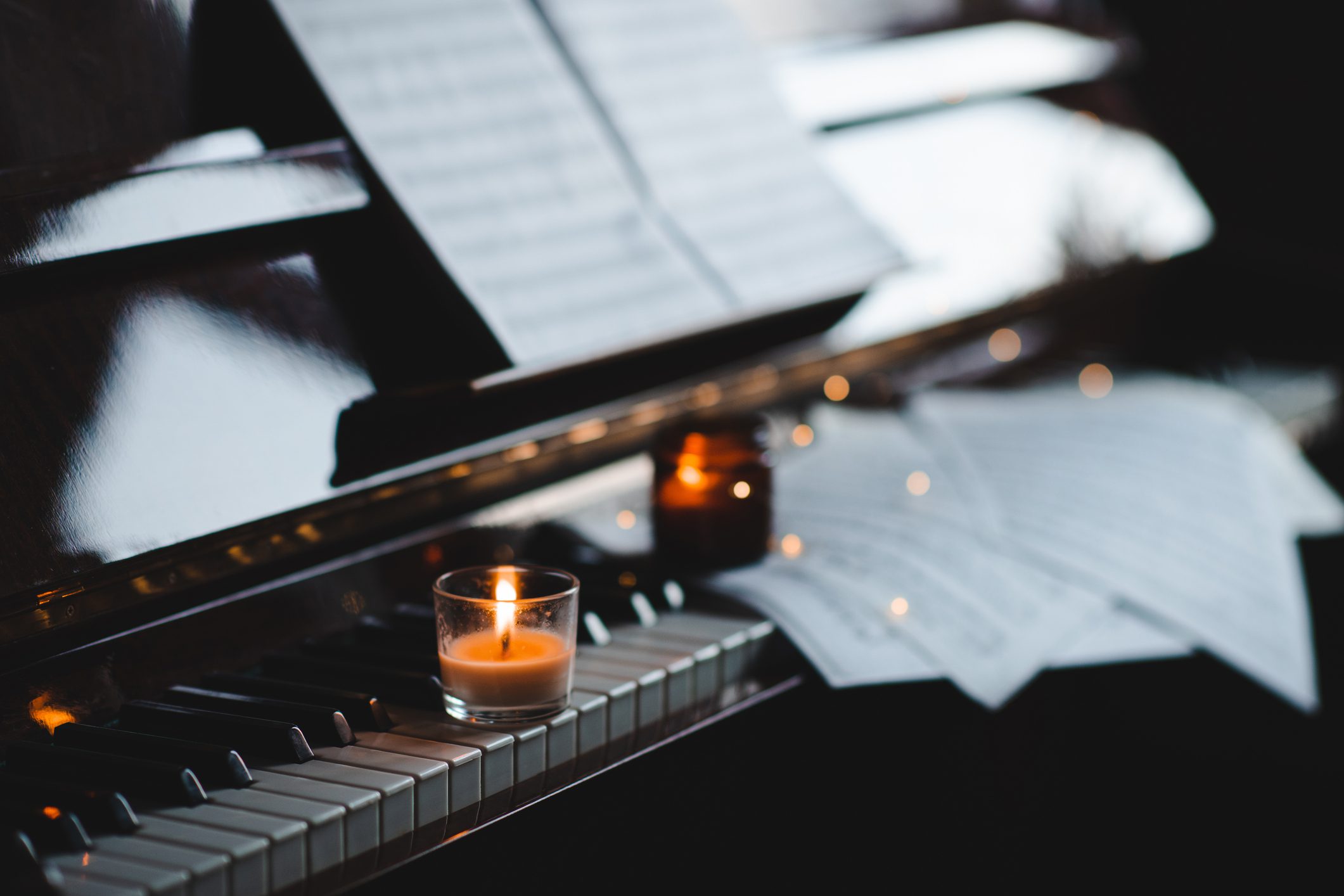 Candlelit piano with sheet music