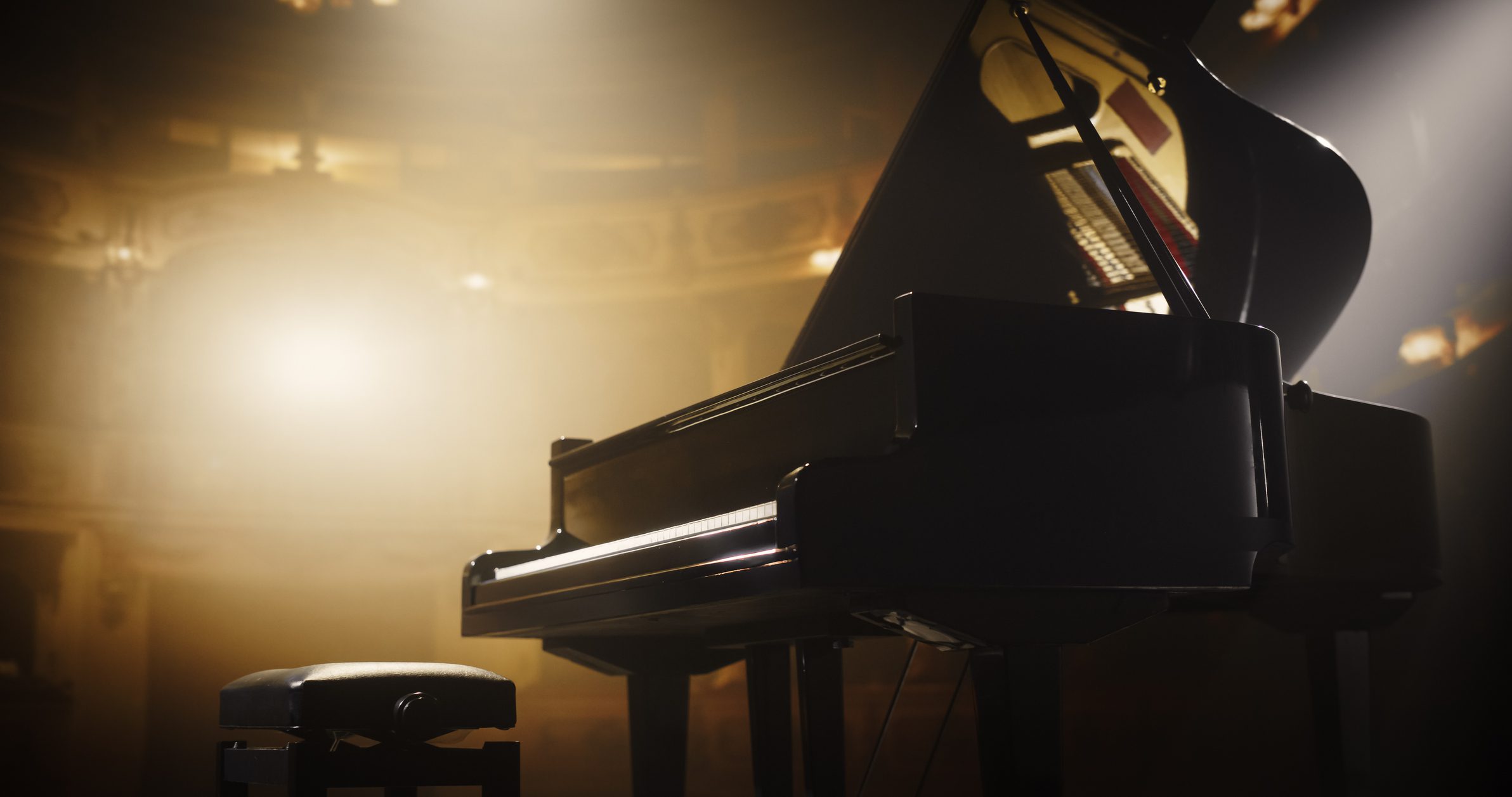 Grand piano on stage with spotlight