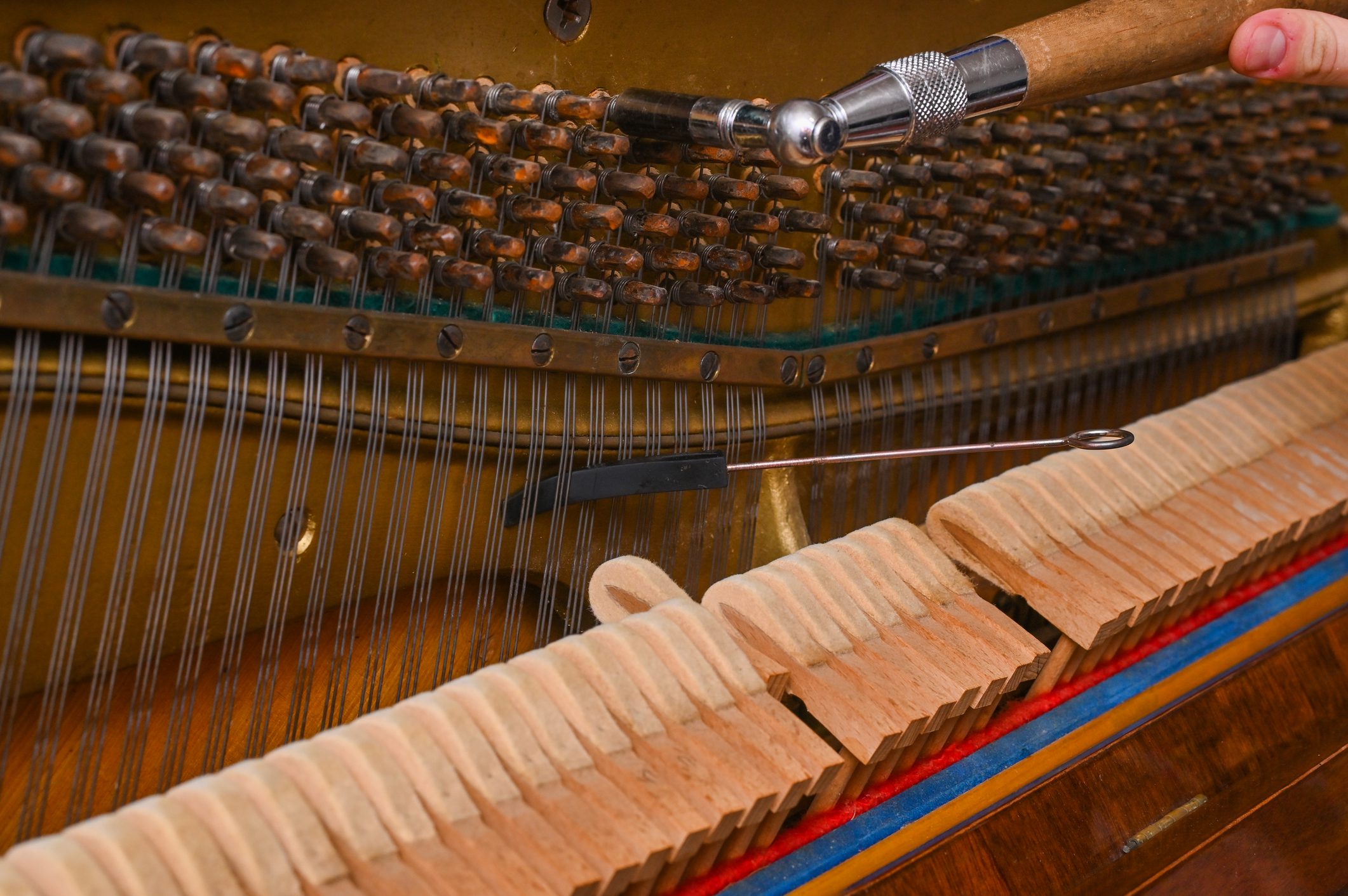 Hand tuning a piano string