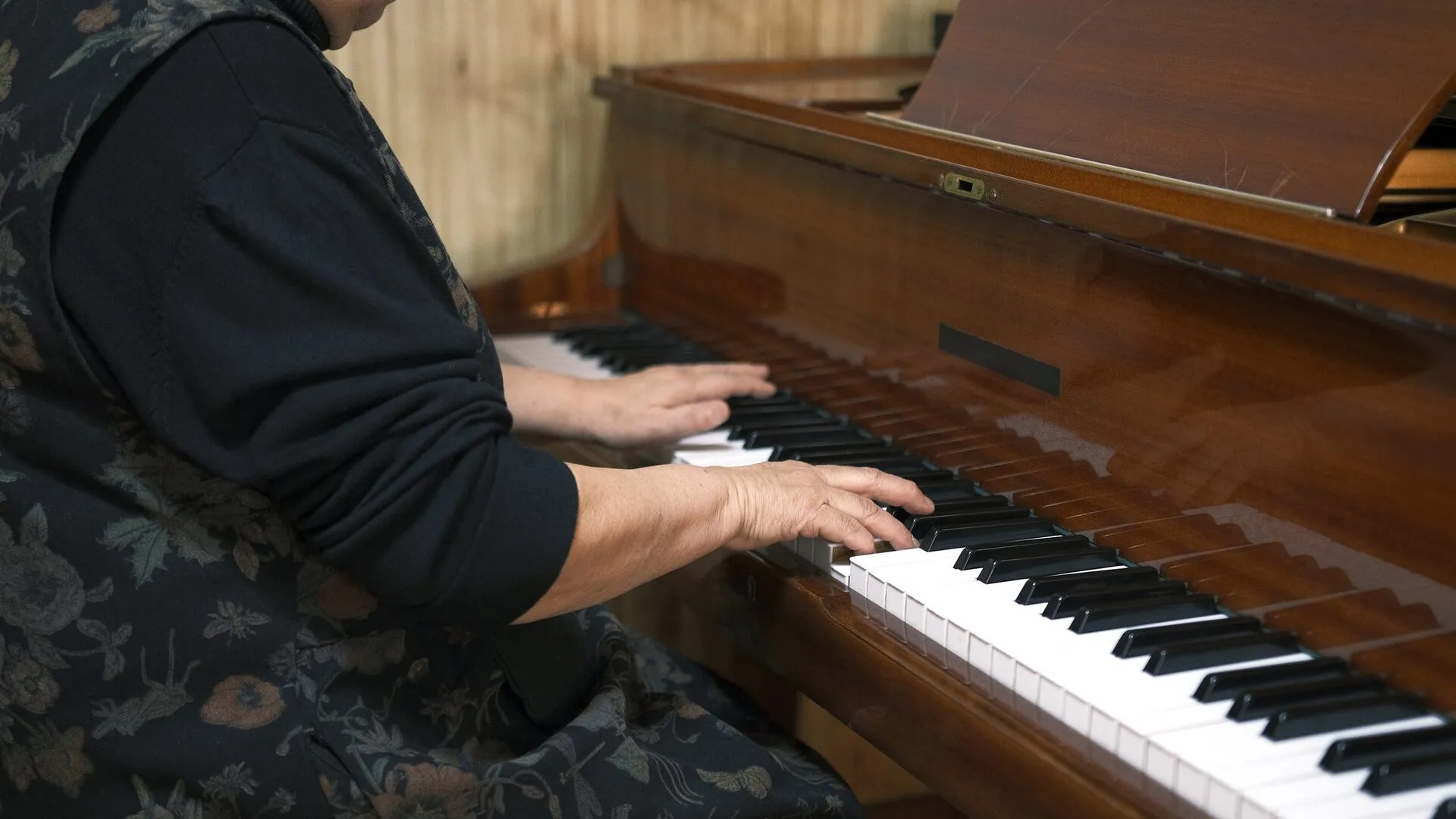 Musician's hands on piano keys