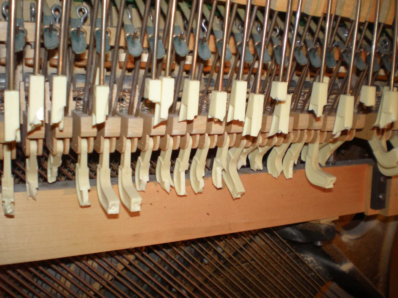 Close-up of piano hammers inside an upright piano